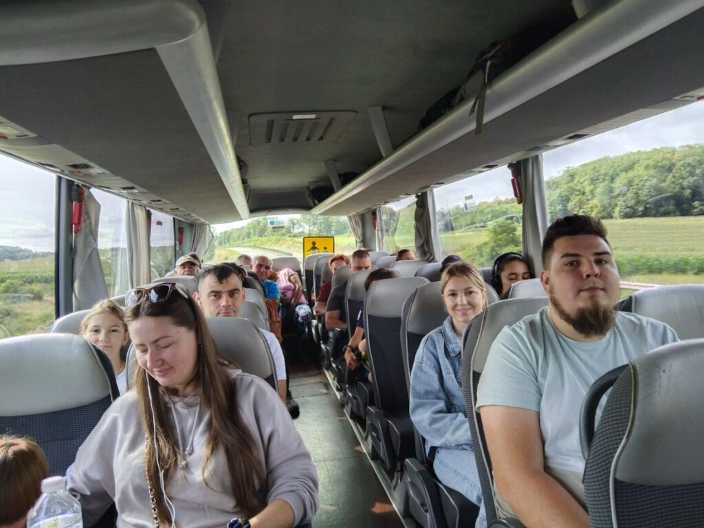 hommes, femmes et enfants assis dans un bus